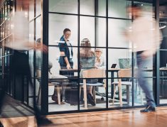Inside view of an office building with blurred motion Business persons around the office building